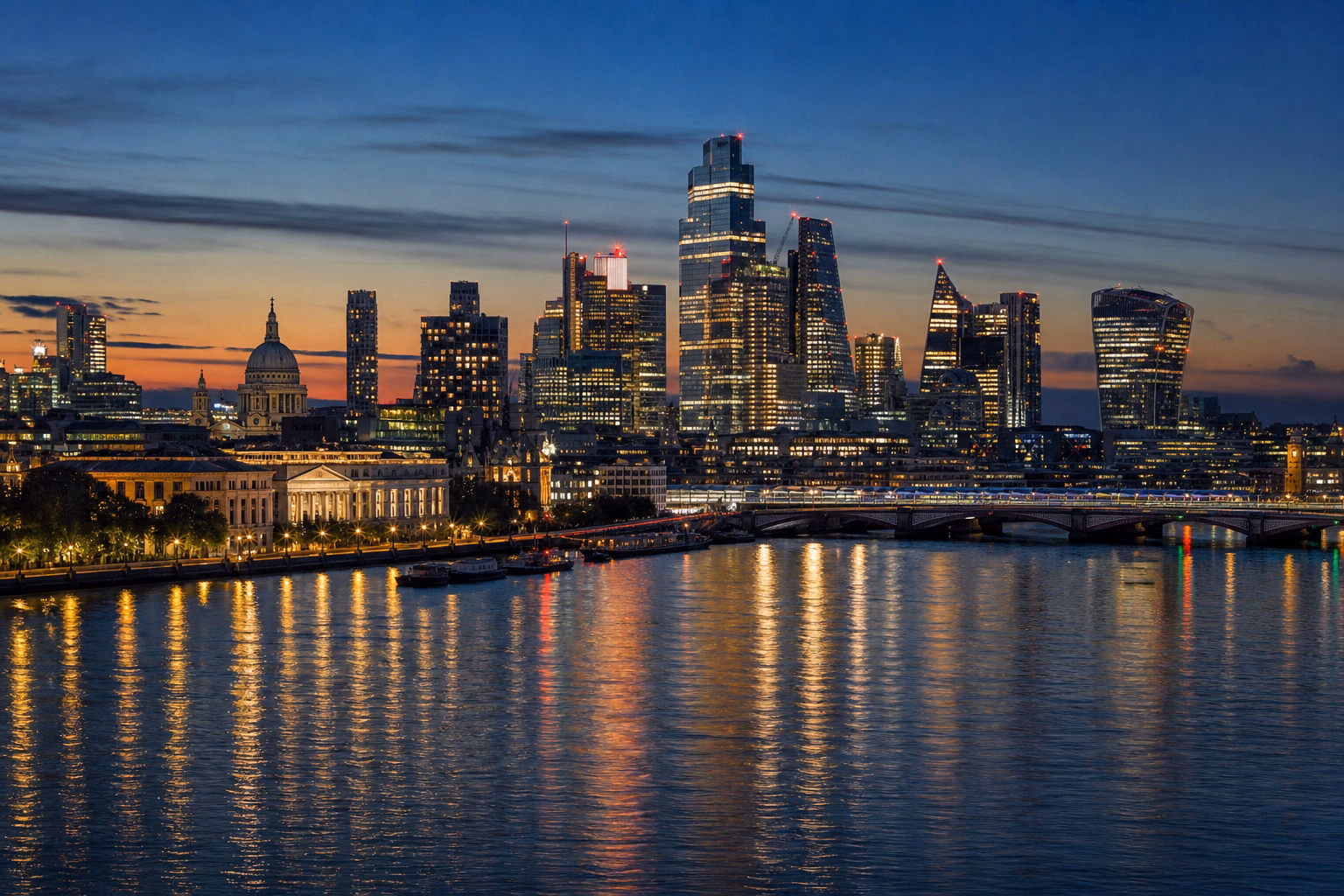 A major international financial and civic skyline illuminated across the water at twilight
